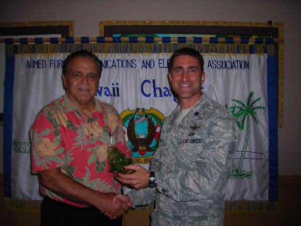 Cory Lindo (l), chapter president, presents a token of appreciation to the October luncheon speaker Lt. Col. Michael Rich, USAF, commander, 352nd Network Warfare Squadron.